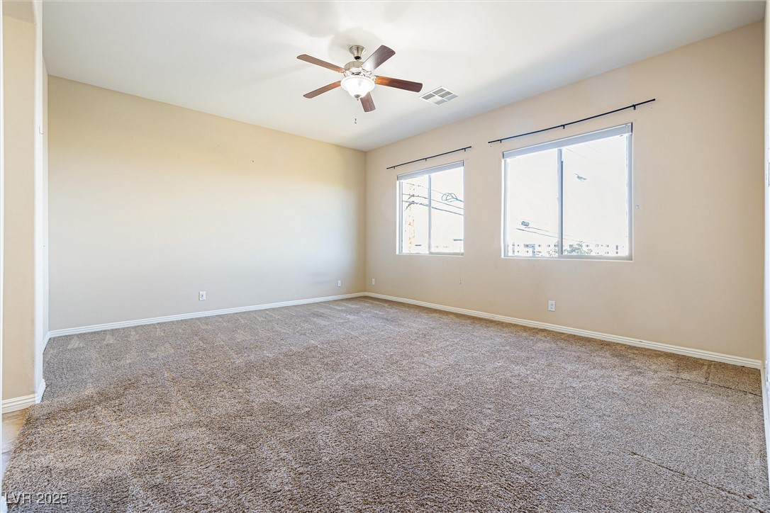 60 Newton Ridge Way Las Vegas, NV 89183 - Photo 27 of 44 Spare room with light carpet and ceiling fan