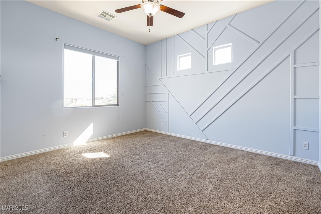 60 Newton Ridge Way Las Vegas, NV 89183 - Photo 30 of 44 Empty room featuring carpet and a ceiling fan