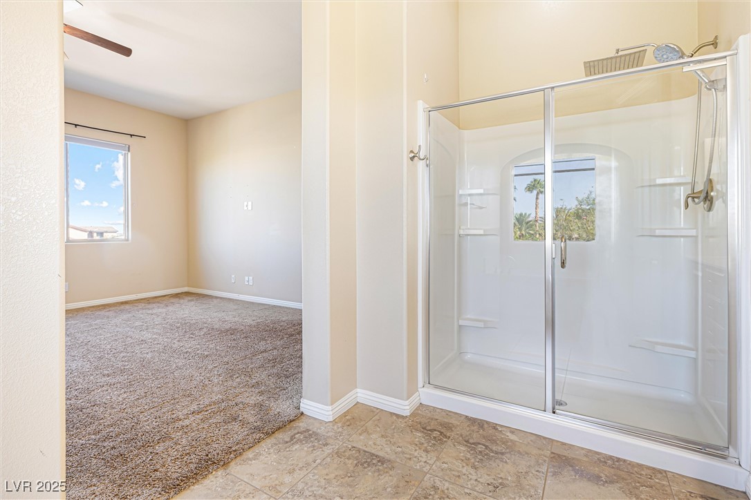 60 Newton Ridge Way Las Vegas, NV 89183 - Photo 34 of 44 Full bath featuring a shower stall and a ceiling fan