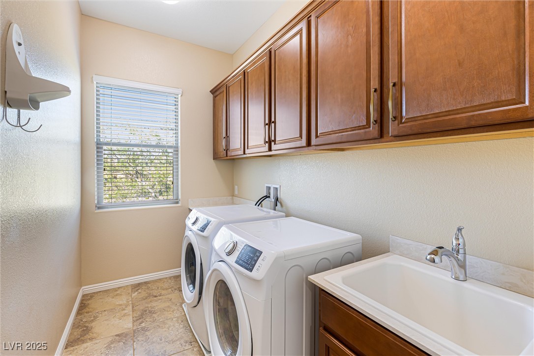 60 Newton Ridge Way Las Vegas, NV 89183 - Photo 35 of 44 Laundry room featuring a textured wall, independent washer and dryer, and cabinet space