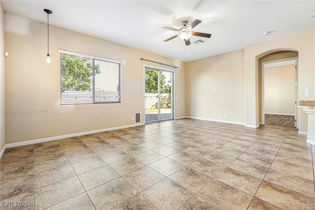 60 Newton Ridge Way Las Vegas, NV 89183 - Photo 6 of 44 Unfurnished room with ceiling fan, arched walkways, and light tile patterned floors