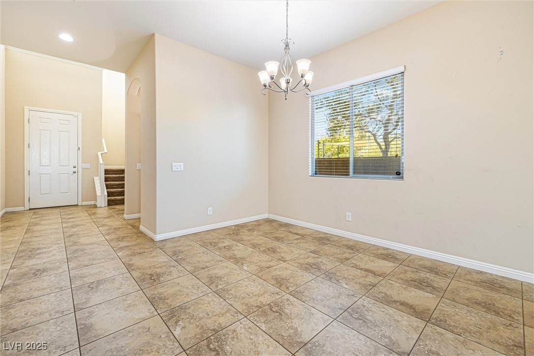 60 Newton Ridge Way Las Vegas, NV 89183 - Photo 7 of 44 Empty room with a chandelier, stairway, and recessed lighting