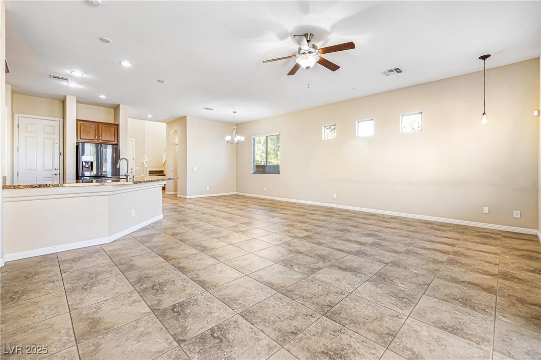 60 Newton Ridge Way Las Vegas, NV 89183 - Photo 8 of 44 Unfurnished living room with a ceiling fan, recessed lighting, a chandelier, and light tile patterned flooring