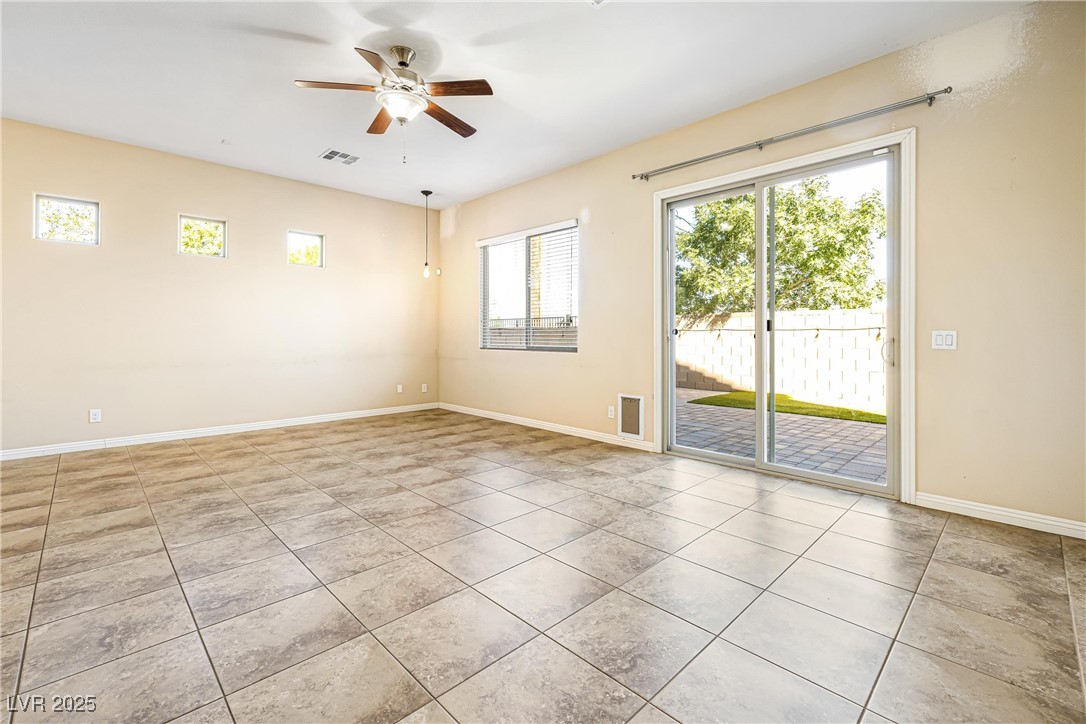 60 Newton Ridge Way Las Vegas, NV 89183 - Photo 9 of 44 Spare room with plenty of natural light, a ceiling fan, and light tile patterned floors
