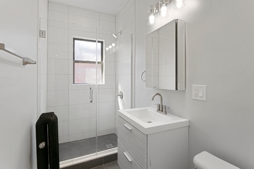 1700 West Juneway Terrace, Unit 3A Chicago, IL 60626 - Photo 12 of 17 a bathroom with a sink a toilet and shower
