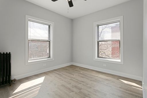 1700 West Juneway Terrace, Unit 3A Chicago, IL 60626 - Photo 9 of 17 a view of an empty room with a window and wooden floor