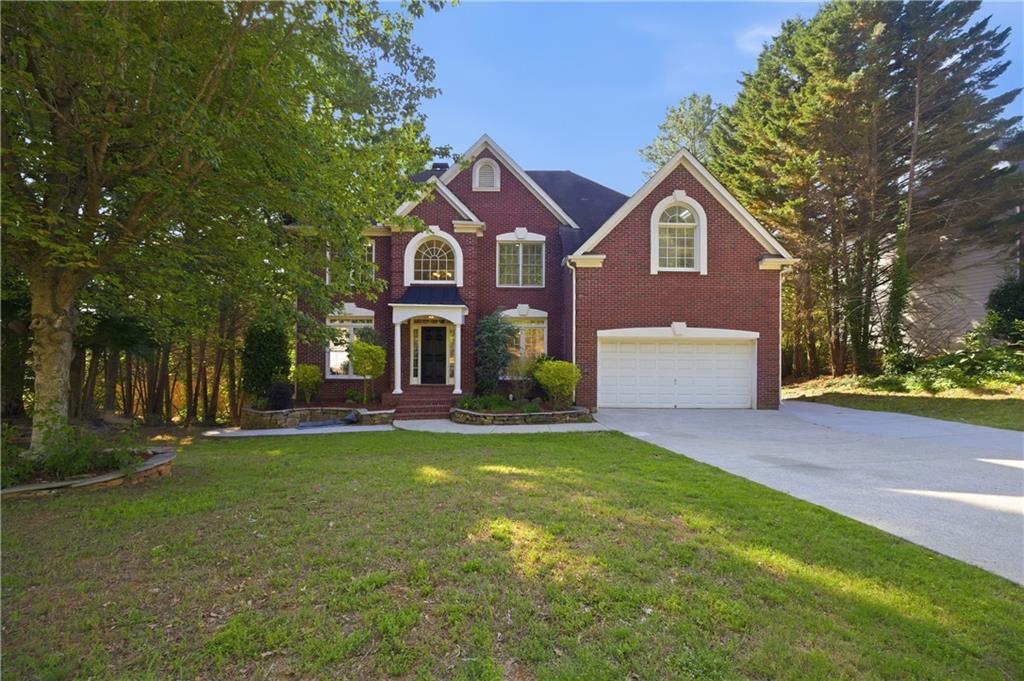 110 Mayes Farm Road Northwest Marietta, GA 30064 - Photo 2 of 49 a front view of a house with a yard and garage