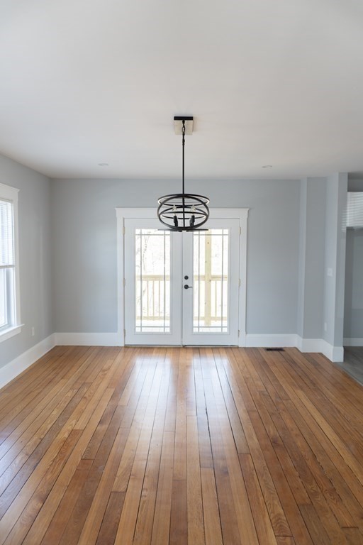 22 Riverside Court Saugus, MA 01906 - Photo 12 of 33 a view of an empty room with wooden floor and a window