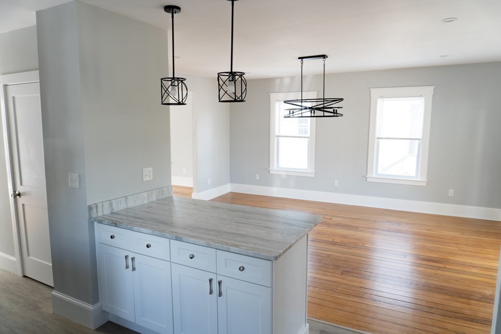 22 Riverside Court Saugus, MA 01906 - Photo 13 of 33 a view of a kitchen counter space with wooden floor and window