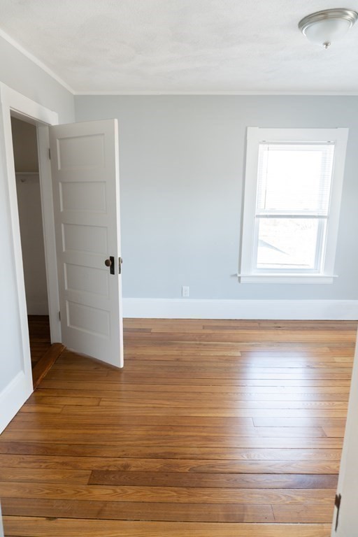 22 Riverside Court Saugus, MA 01906 - Photo 27 of 33 a view of an empty room with wooden floor and a window