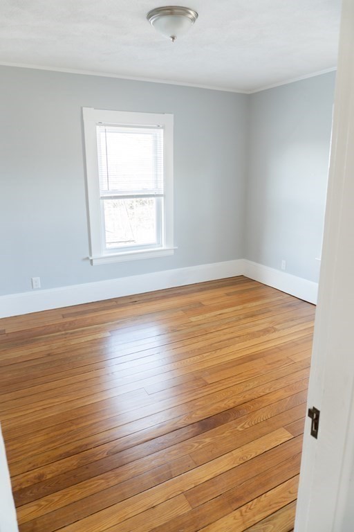22 Riverside Court Saugus, MA 01906 - Photo 28 of 33 an empty room with wooden floor and windows