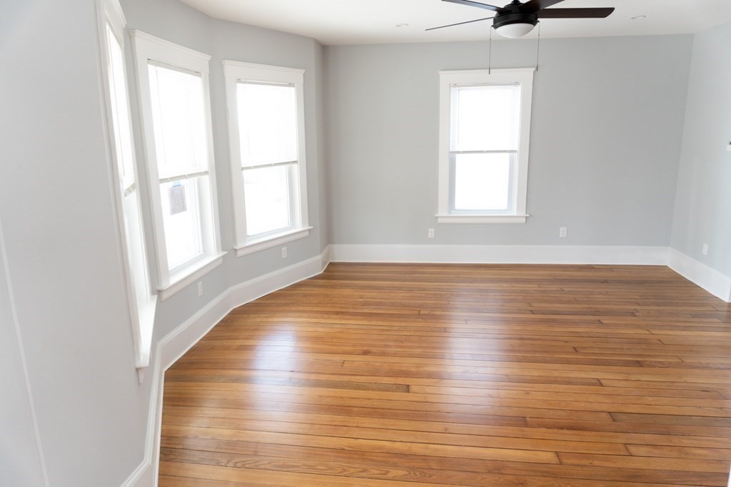 22 Riverside Court Saugus, MA 01906 - Photo 9 of 33 an empty room with wooden floor and windows