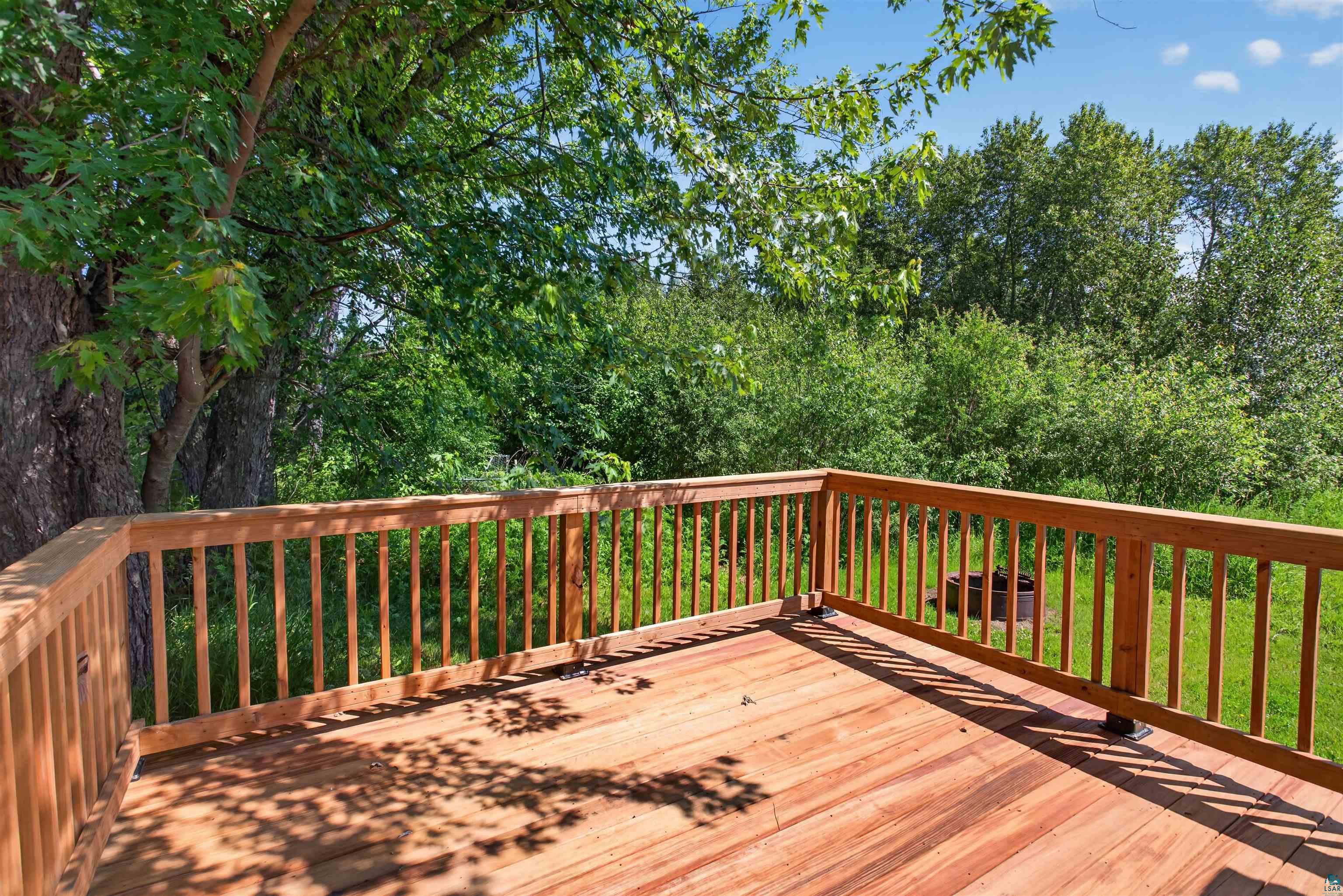 5868 Rice Lake Road Duluth, MN 55803 - Photo 20 of 39 Expansive wood deck with a natural wood finish, featuring a full railing system