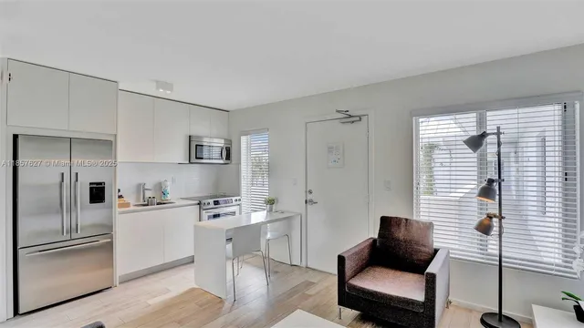 a kitchen with a refrigerator and a sink