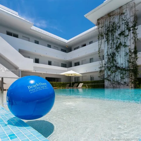 a view of an chairs and table in a room