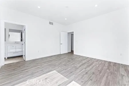 a view of an empty room and wooden floor