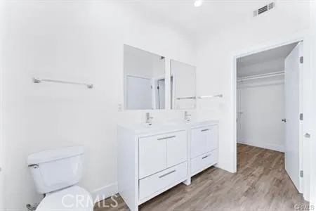 a spacious bathroom with a toilet sink and mirror