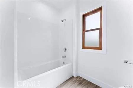 a bathroom with a bathtub and window