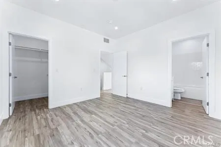 a view of an empty room and wooden floor
