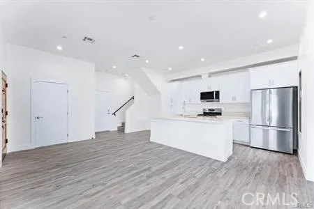 a kitchen with stainless steel appliances a refrigerator and a stove top oven