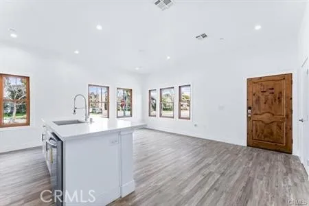 a view of a kitchen with furniture and wooden floor