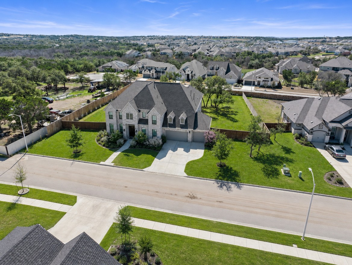 1440 Riva Ridge Drive Leander, TX 78641 - Photo 34 of 37 An aerial perspective reveals a handsome residence nestled within a well-maintained neighborhood, showcasing mature landscaping and ample green space.