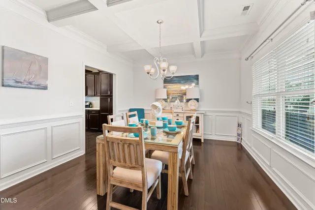 a view of a dining room with furniture wooden floor and chandelier