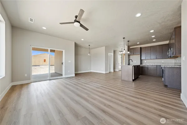 a view of a kitchen with a sink and wooden floor