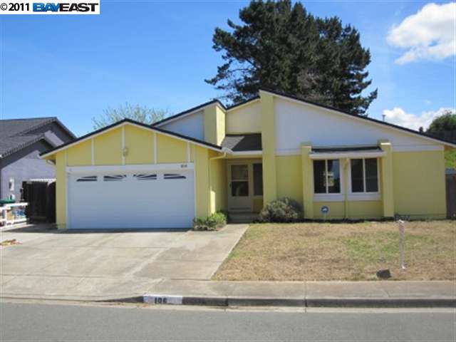 a front view of a house with a garden and garage