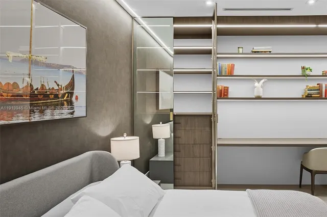 a bedroom with a bed and a painting on the wall