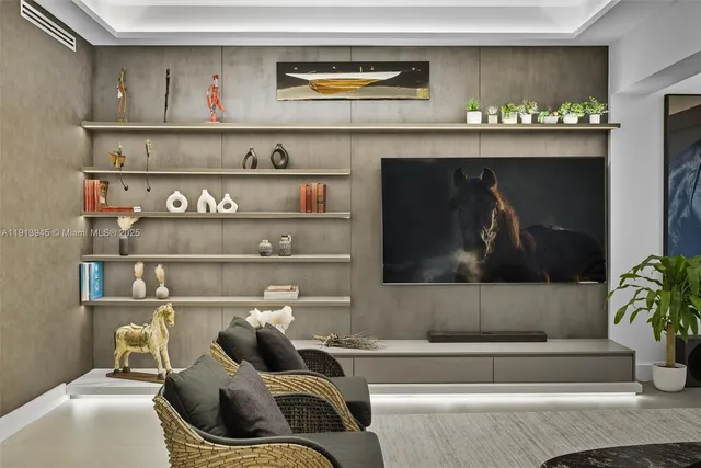 a living room with furniture and large windows