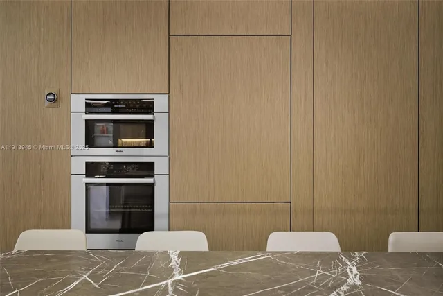 a kitchen with a table chairs and a refrigerator