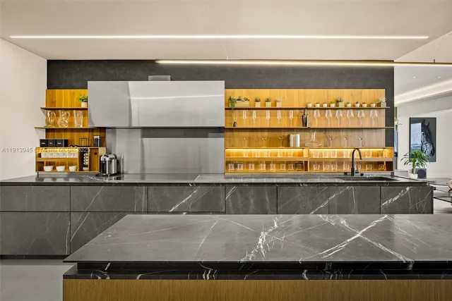 a kitchen with stainless steel appliances granite countertop a sink and a refrigerator