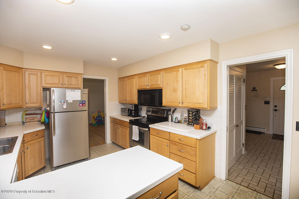 105 Sturbridge Road Clarks Summit, PA 18411 - Photo 11 of 56 a kitchen with a refrigerator stove and sink