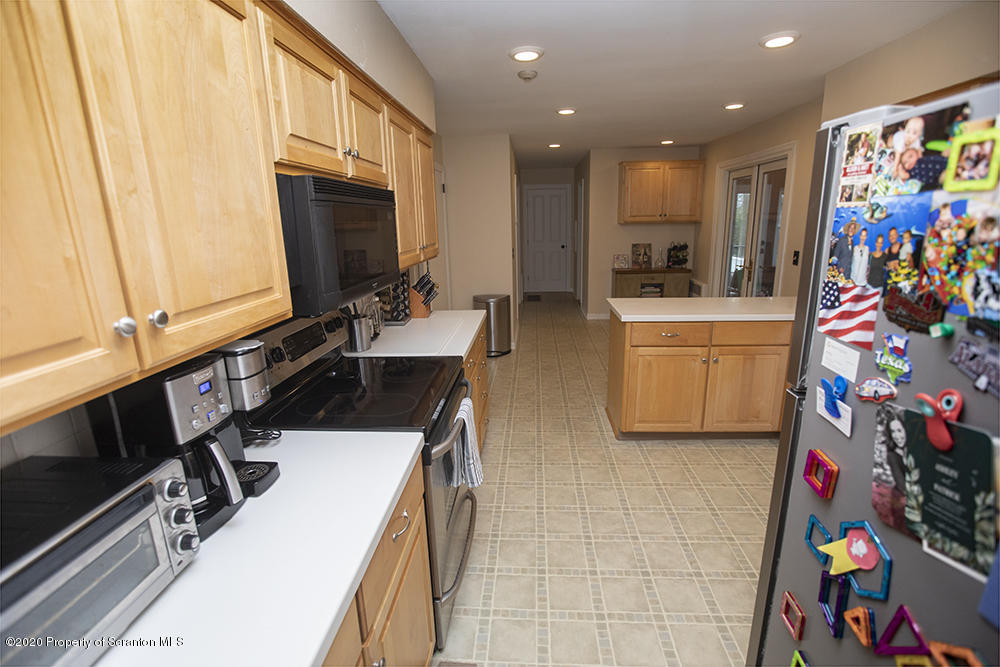 105 Sturbridge Road Clarks Summit, PA 18411 - Photo 13 of 56 a kitchen with stainless steel appliances a stove a sink and a refrigerator