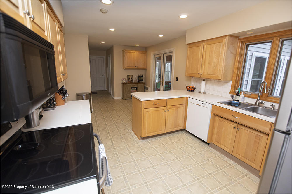 105 Sturbridge Road Clarks Summit, PA 18411 - Photo 14 of 56 a large kitchen with stainless steel appliances a stove a sink a microwave a refrigerator and cabinets