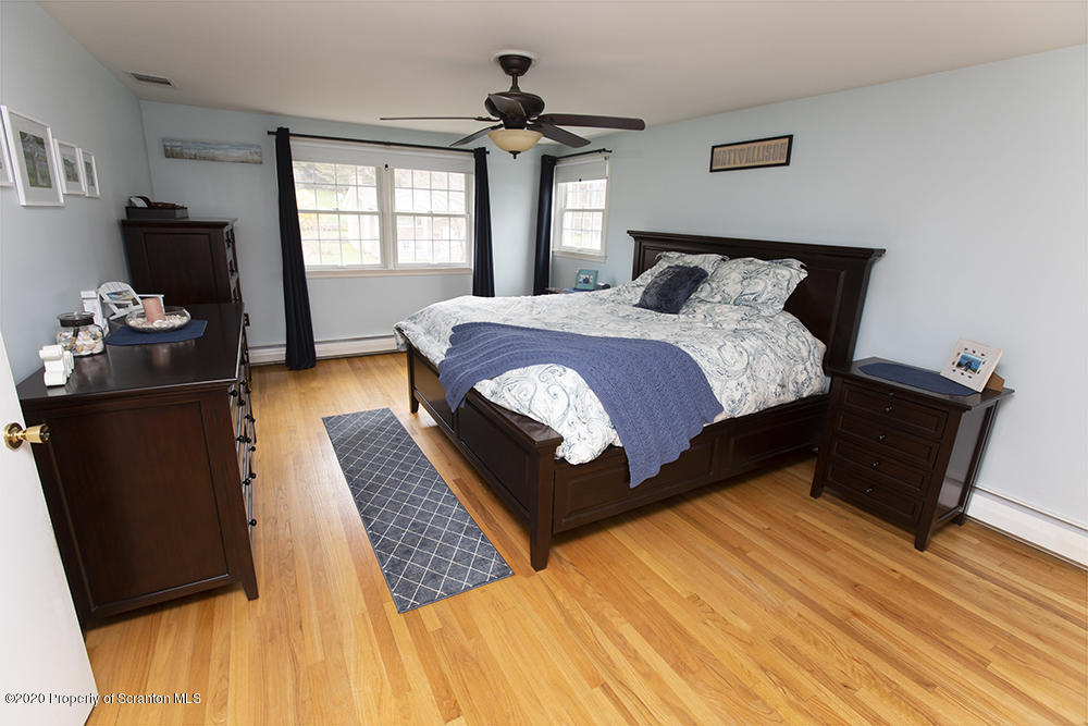 105 Sturbridge Road Clarks Summit, PA 18411 - Photo 26 of 56 a bedroom with a bed and wooden floor