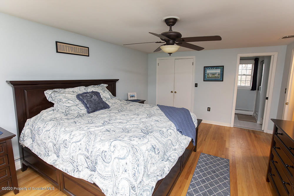 105 Sturbridge Road Clarks Summit, PA 18411 - Photo 27 of 56 a bedroom with a bed and a chandelier