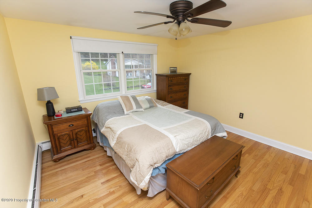 105 Sturbridge Road Clarks Summit, PA 18411 - Photo 30 of 56 a bedroom with a bed and wooden floor