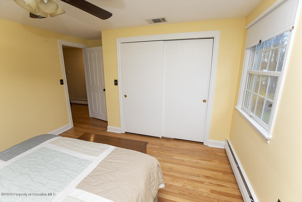 105 Sturbridge Road Clarks Summit, PA 18411 - Photo 31 of 56 a bedroom with a bed and wooden floor