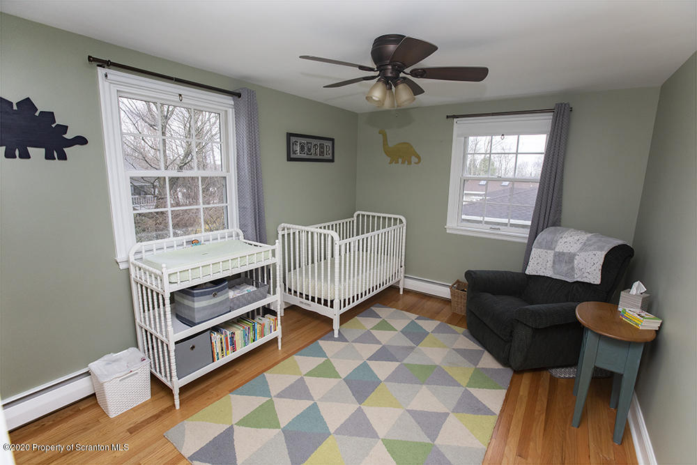105 Sturbridge Road Clarks Summit, PA 18411 - Photo 35 of 56 a living room with furniture a window and a flat screen tv