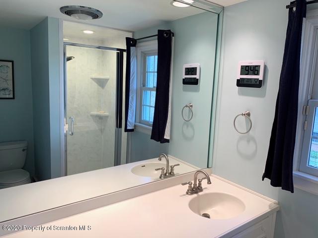 105 Sturbridge Road Clarks Summit, PA 18411 - Photo 38 of 56 a bathroom with a sink vanity granite tub and a mirror