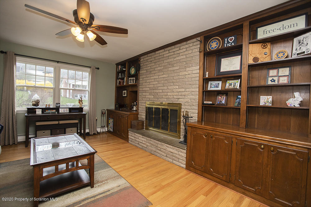 105 Sturbridge Road Clarks Summit, PA 18411 - Photo 7 of 56 a living room with furniture a flat screen tv and a fireplace