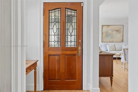 a view of a hallway with wooden floor and entryway