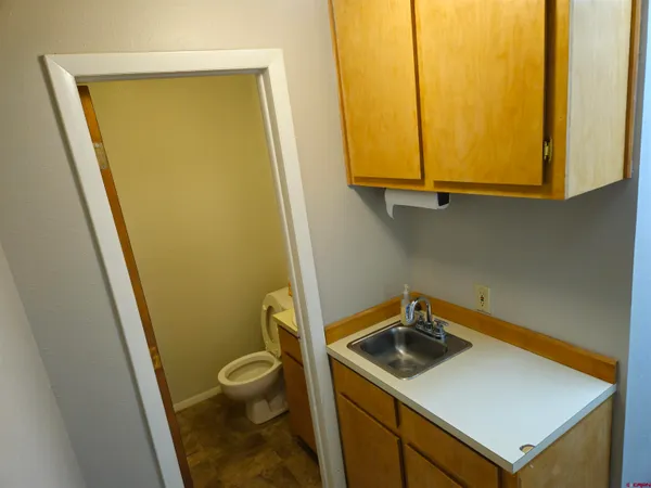 a bathroom with a sink and a washer dryer