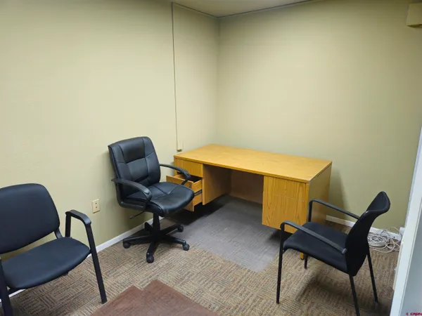 a work room with furniture and a piano
