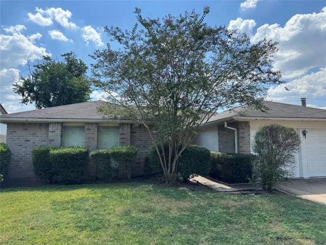 a view of a house with a yard and a garden