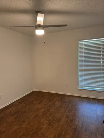 a view of a room with wooden floor closet and windows