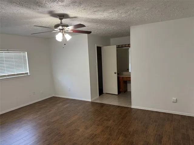 a view of a livingroom with a ceiling fan and window