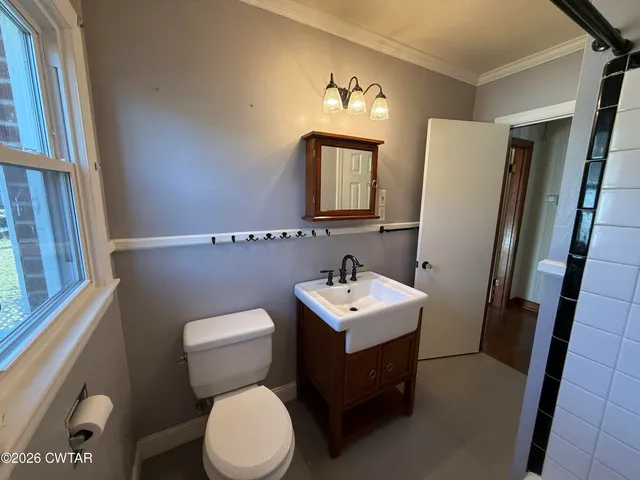 a bathroom with a toilet a sink and a mirror